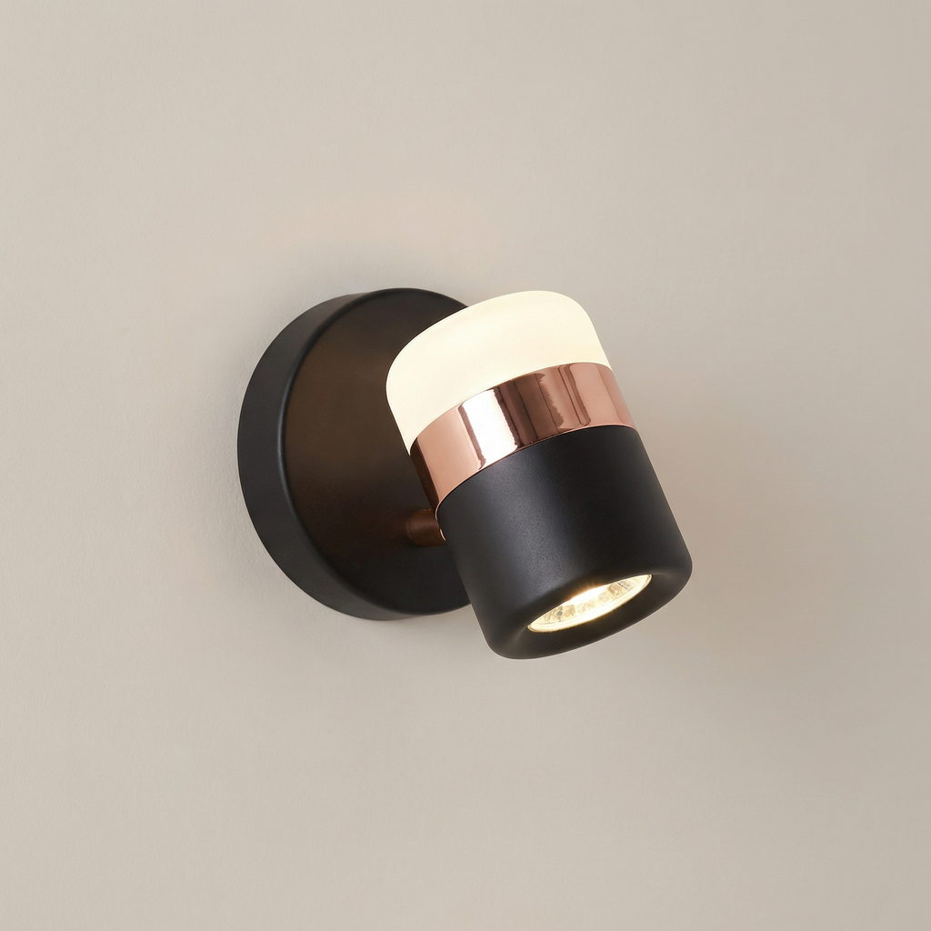 Modern wall light fixture with black and copper design on a neutral background